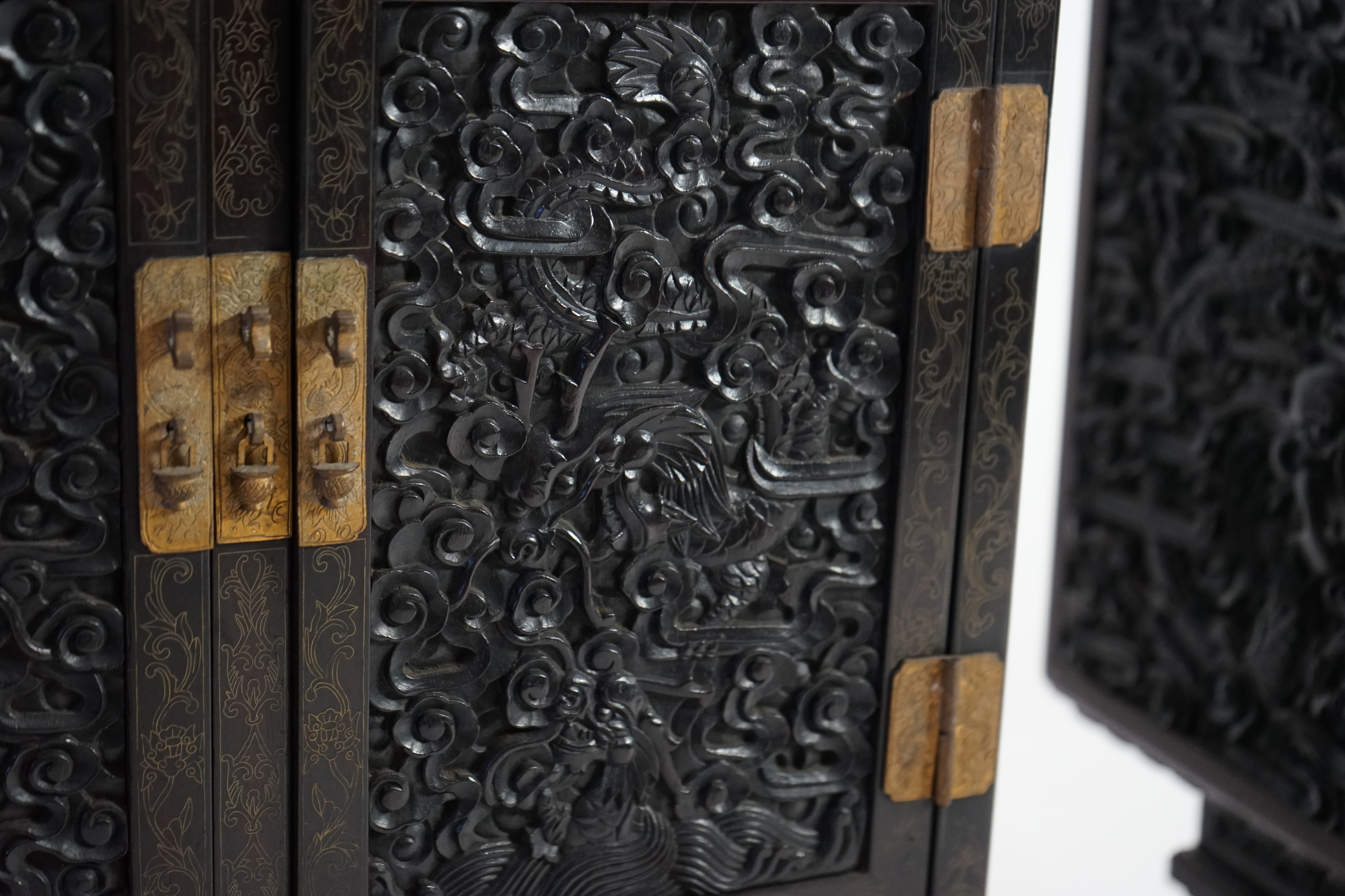 An important pair of Chinese carved zitan and silver wire inlaid ‘cloud and dragon’ curio cabinets and stands, duobaoge, probably Imperial, late Qing dynasty